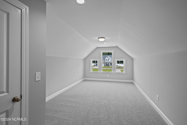 bonus room featuring lofted ceiling and carpet floors