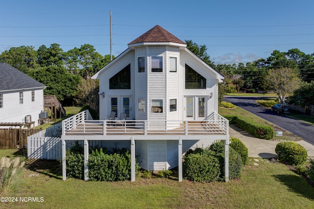 back of house with a deck and a yard