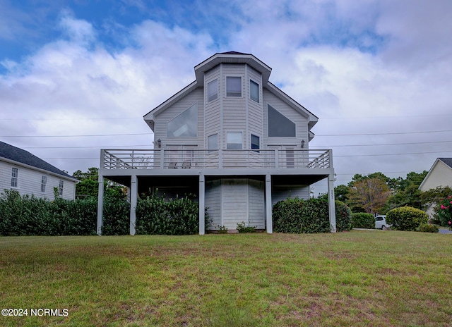 rear view of property with a deck and a lawn