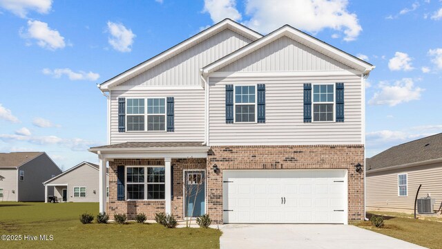 view of front of house with central AC unit, a garage, and a front lawn