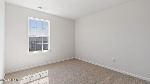 unfurnished bedroom featuring light colored carpet