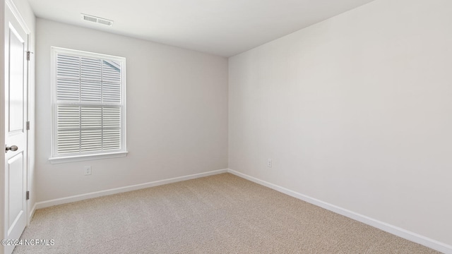 empty room featuring light carpet