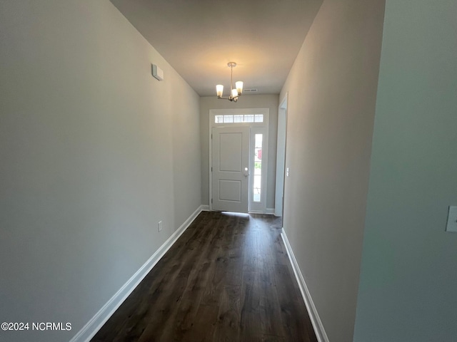 entryway featuring dark hardwood / wood-style flooring and a notable chandelier