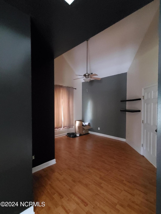 unfurnished living room featuring high vaulted ceiling, ceiling fan, and light wood-type flooring