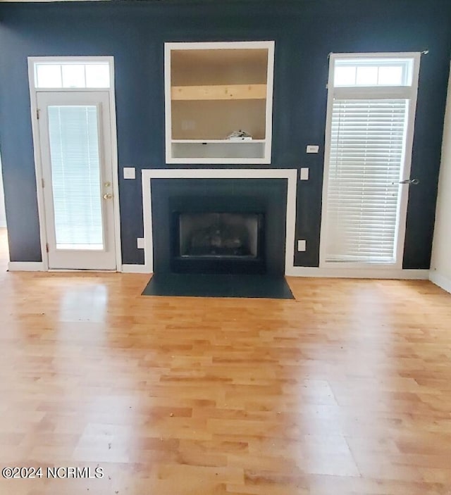 unfurnished living room with light wood-type flooring