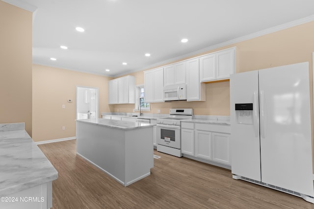 kitchen with white cabinets, a center island, white appliances, and light hardwood / wood-style flooring