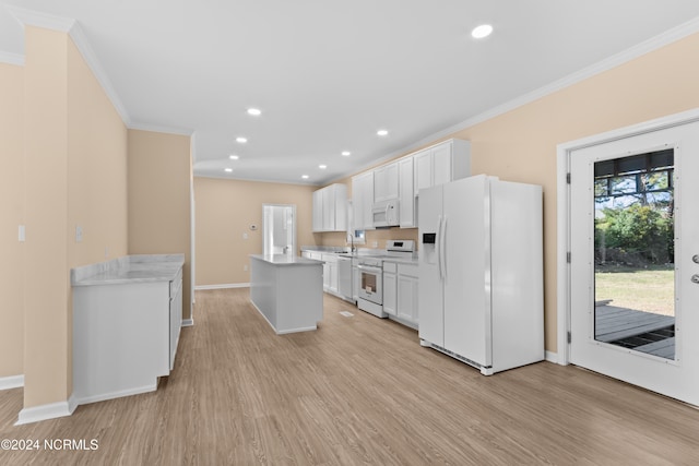 kitchen featuring white cabinets, light wood-type flooring, white appliances, and ornamental molding