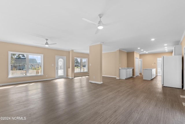 unfurnished living room featuring ceiling fan, crown molding, and wood-type flooring