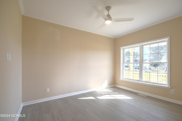 spare room featuring ceiling fan, hardwood / wood-style floors, and crown molding