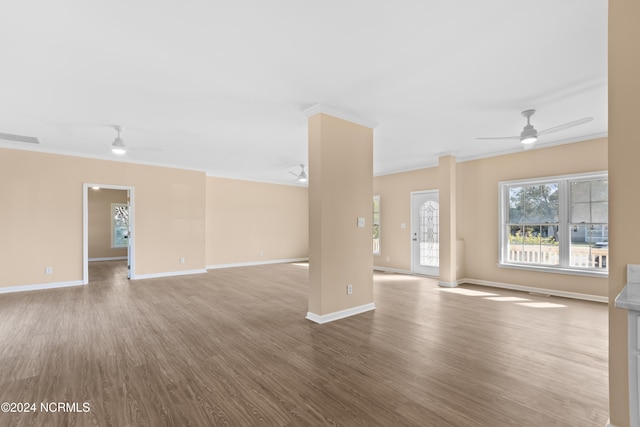 unfurnished living room featuring light hardwood / wood-style floors, ceiling fan, and ornamental molding