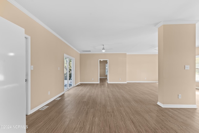 unfurnished living room with ceiling fan, hardwood / wood-style floors, and ornamental molding