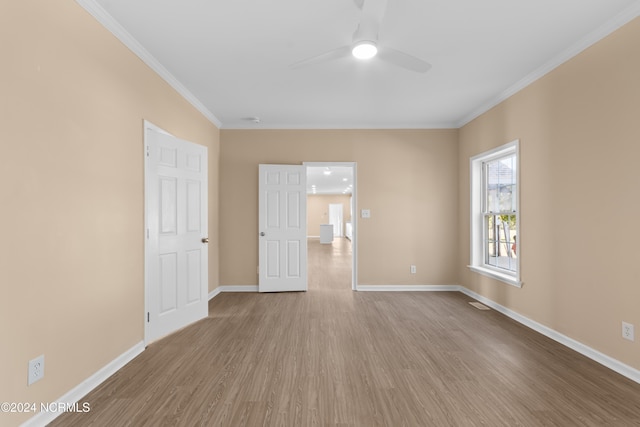 spare room featuring ceiling fan, light hardwood / wood-style flooring, and crown molding