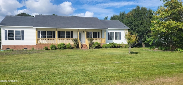 ranch-style home with covered porch and a front yard