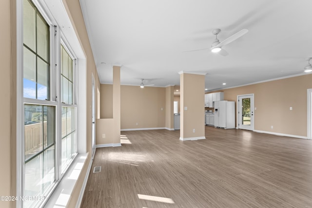 unfurnished living room featuring hardwood / wood-style floors, ceiling fan, and ornamental molding