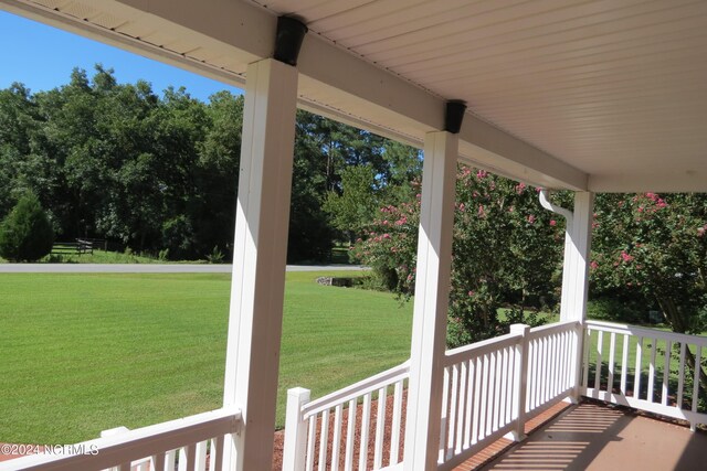 wooden terrace with a yard and a porch