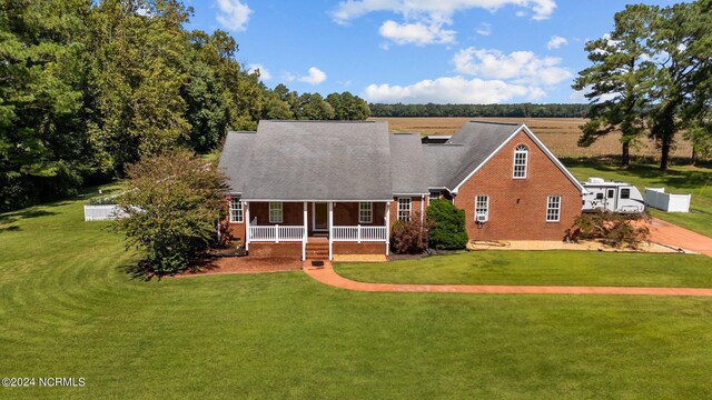 view of front of house featuring a front yard and covered porch