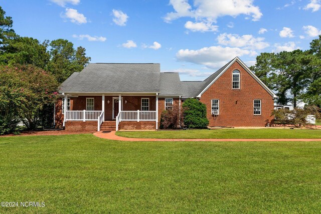 cape cod-style house featuring a front yard and a porch