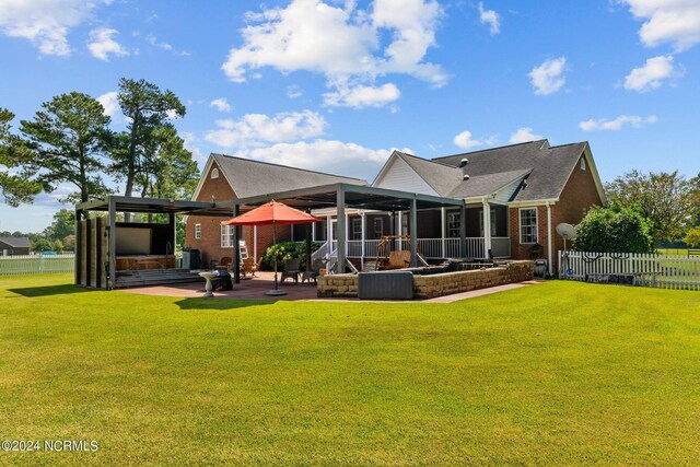 back of property featuring a lawn and a patio area