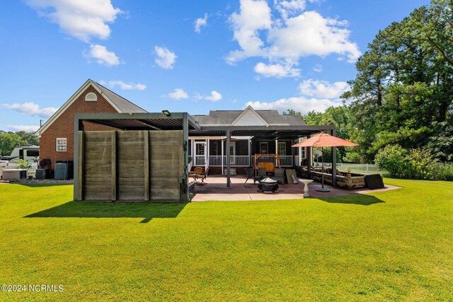 back of property with a lawn, a patio, and central air condition unit