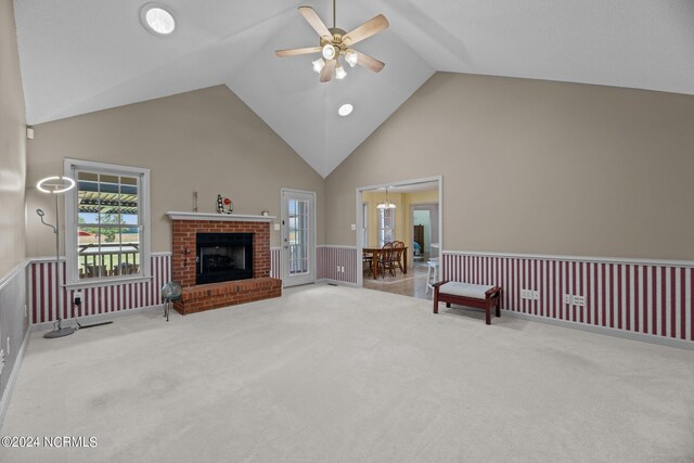 carpeted living room with high vaulted ceiling, ceiling fan, and a brick fireplace