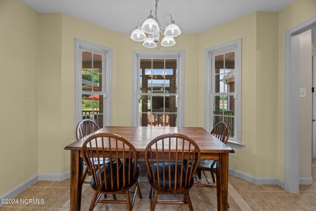 tiled dining space with an inviting chandelier