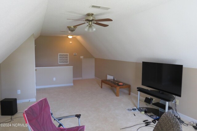 interior space with ceiling fan, light carpet, and vaulted ceiling