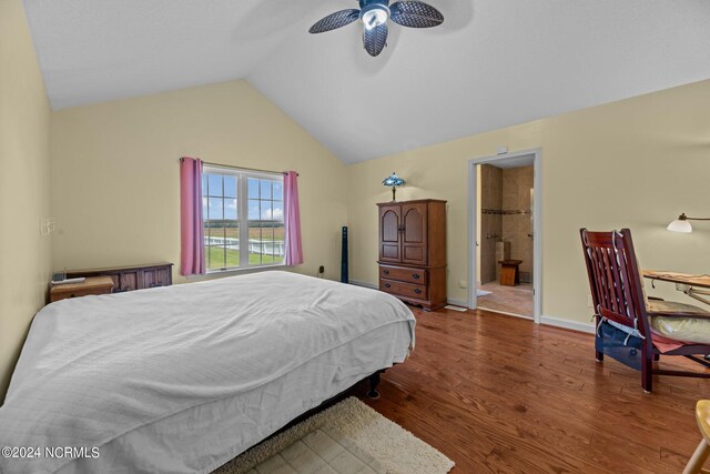 bedroom with ceiling fan, lofted ceiling, ensuite bath, and dark hardwood / wood-style floors