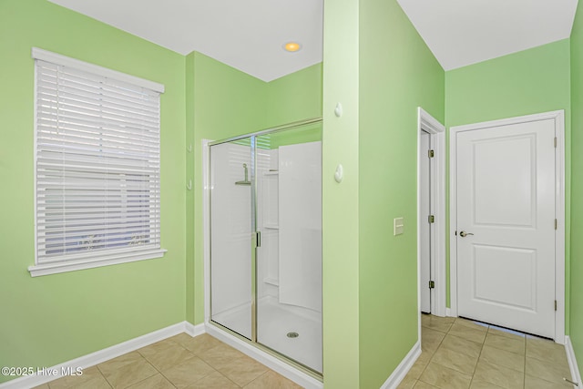 bathroom featuring a shower with door and tile patterned floors