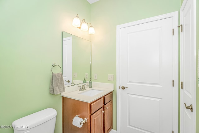 bathroom with toilet and vanity