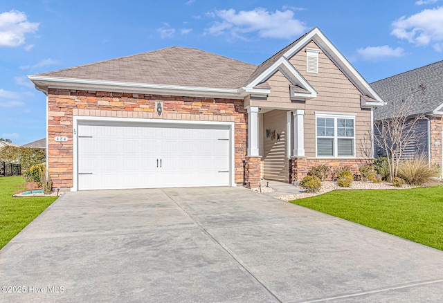 craftsman-style home featuring a front yard and a garage