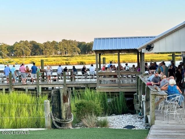 view of dock with a deck with water view