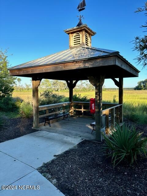 view of community featuring a wooden deck, a rural view, and a gazebo