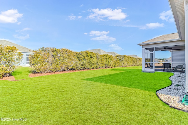 view of yard with a sunroom and a patio