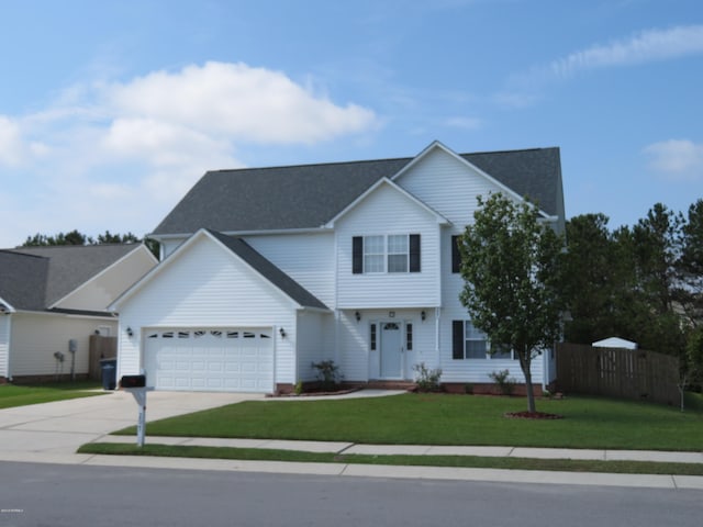 view of front of home featuring a garage and a front lawn