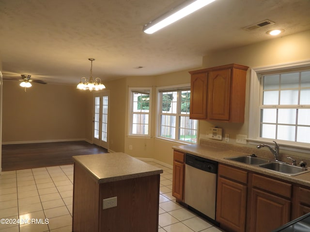 kitchen featuring ceiling fan with notable chandelier, light hardwood / wood-style flooring, dishwasher, a kitchen island, and sink