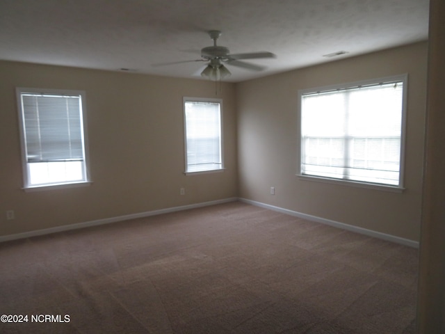 carpeted empty room featuring ceiling fan