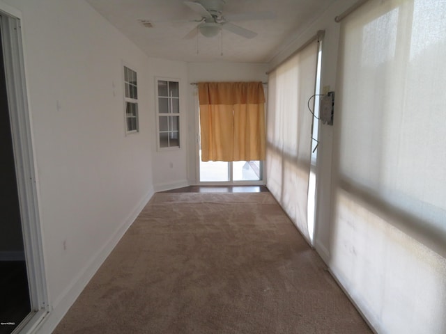 carpeted spare room with ceiling fan