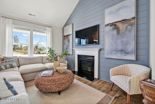 living room featuring hardwood / wood-style floors and vaulted ceiling