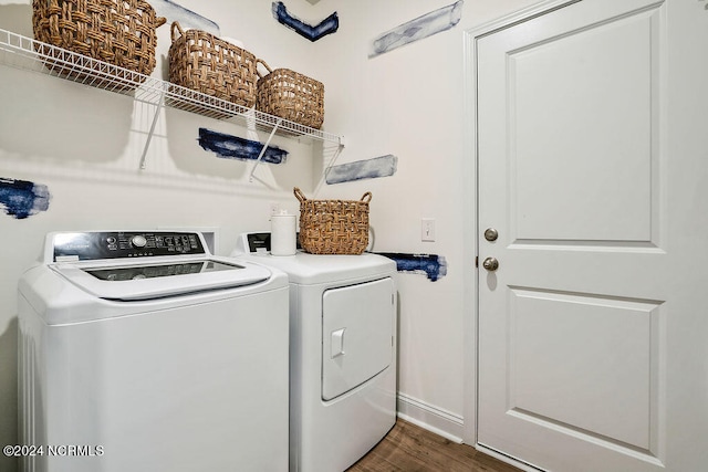 clothes washing area with washing machine and dryer and dark hardwood / wood-style flooring