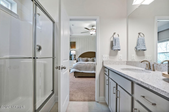 bathroom with tile patterned flooring, ceiling fan, an enclosed shower, and vanity