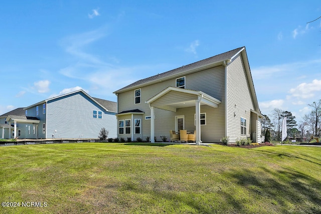 back of property featuring a lawn