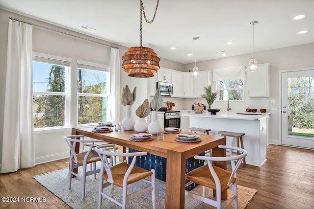 dining space with wood-type flooring