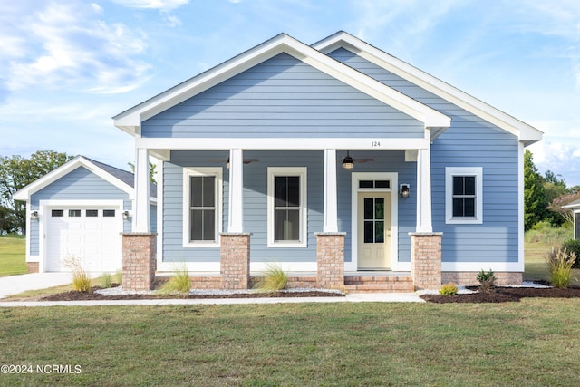 view of front of house with ceiling fan, a front lawn, concrete driveway, covered porch, and a garage