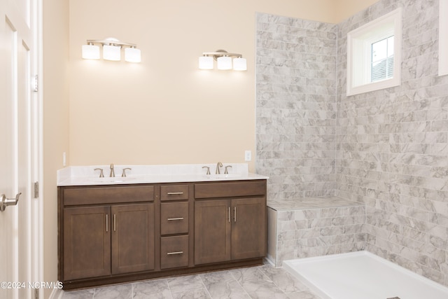 bathroom with vanity and tiled shower