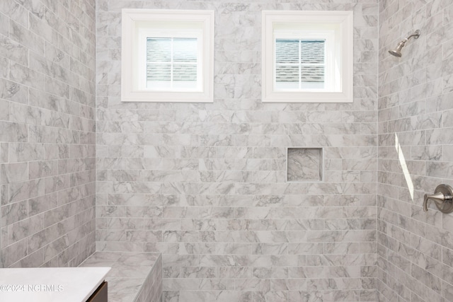 bathroom with tiled shower