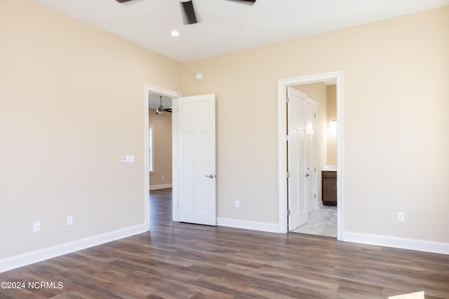 unfurnished bedroom with ceiling fan, connected bathroom, and dark hardwood / wood-style flooring