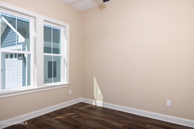 unfurnished room with dark hardwood / wood-style floors