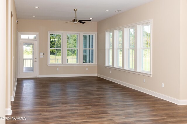 empty room featuring ceiling fan and dark hardwood / wood-style floors