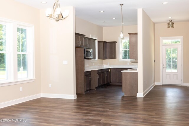 kitchen featuring decorative light fixtures, dark hardwood / wood-style floors, and a healthy amount of sunlight