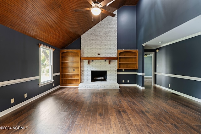 unfurnished living room with a brick fireplace, dark hardwood / wood-style flooring, ornamental molding, ceiling fan, and wooden ceiling